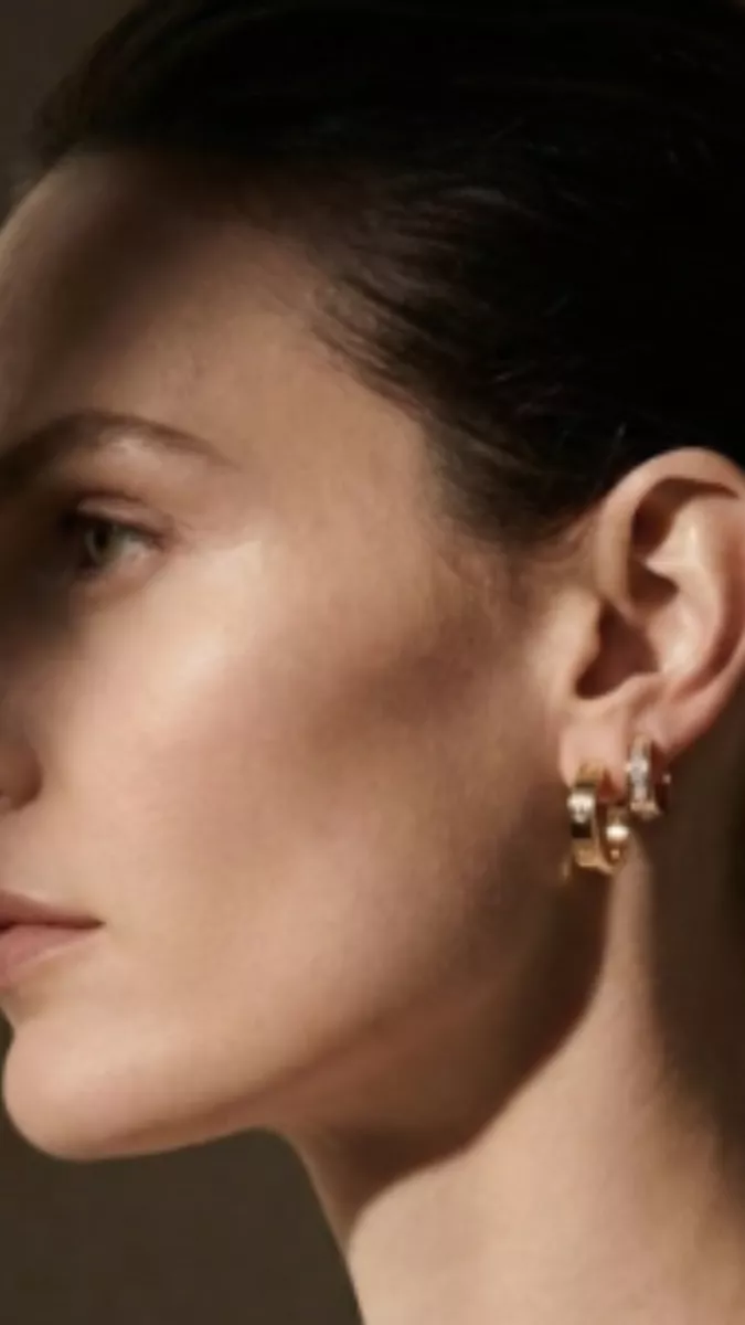 cartier earrings side profile luxury portrait strong contrast minimal background
